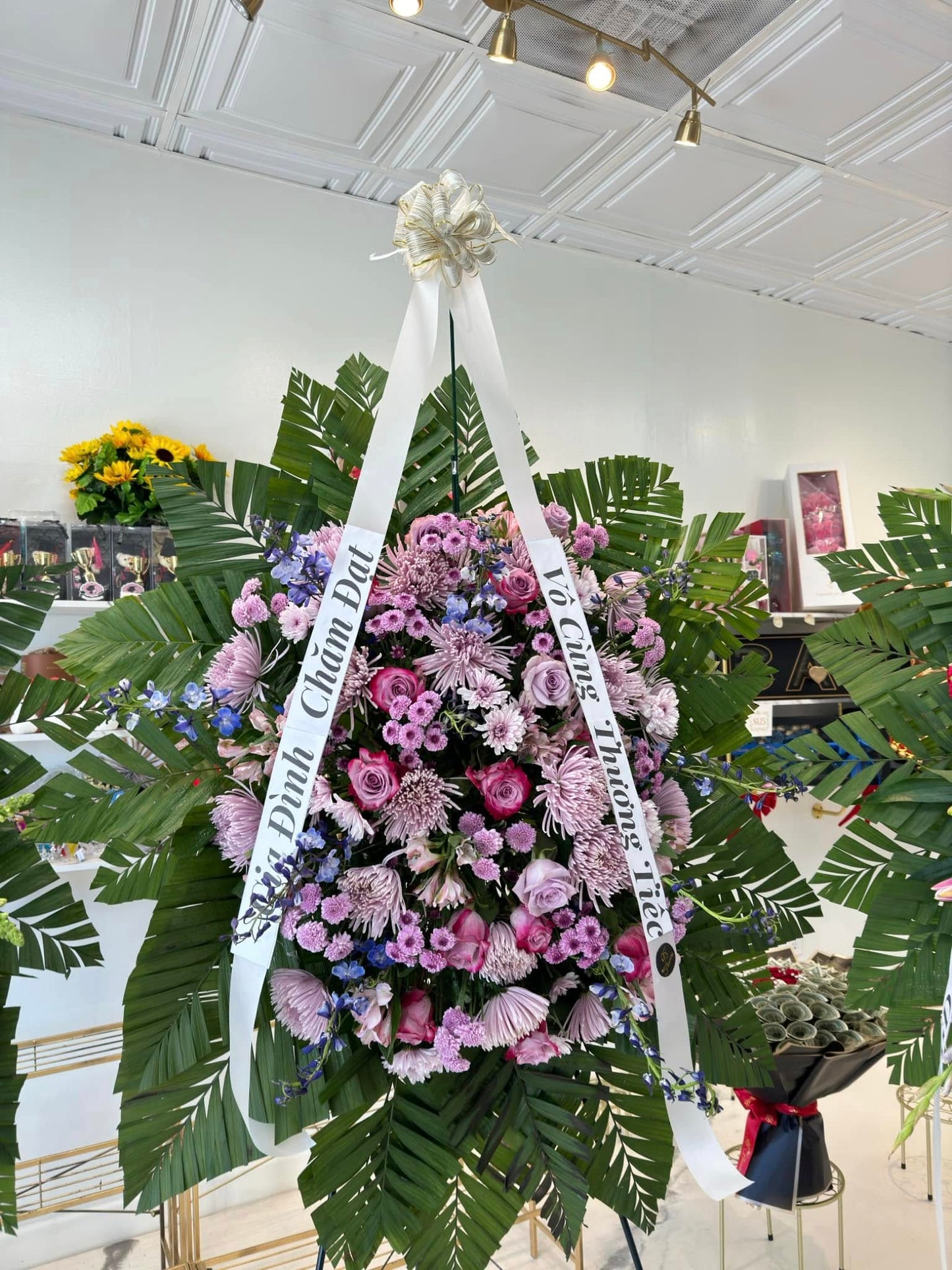 Lavender garden sympathy standing spray with purple flowers and greenery