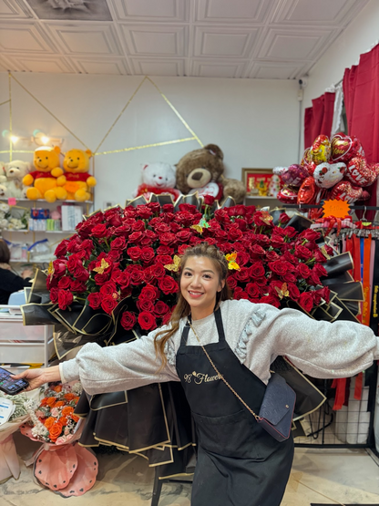 98 Flowers florist standing in front of a super giant bouquet of 200 premium red roses