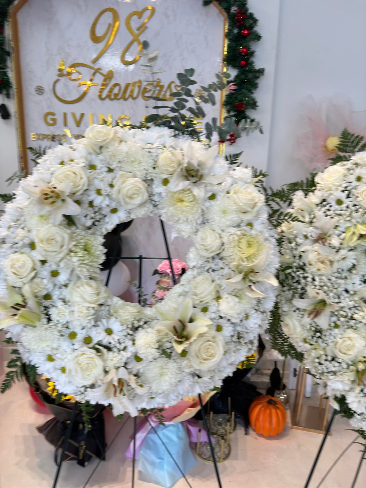 Premium white garden sympathy wreath with roses, lilies and hydrangea