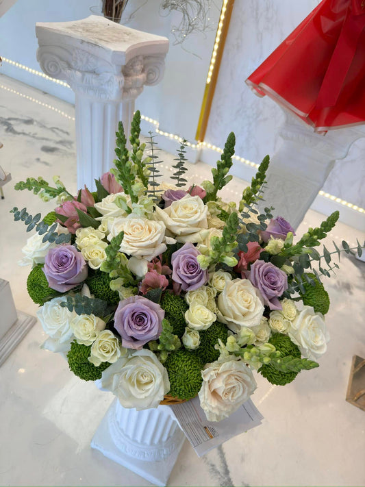 Lavender and white sympathy vase with roses, hydrangea and greenery