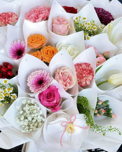 Close-up of mixed roses, gerberas, carnations, orchids, and baby's breath