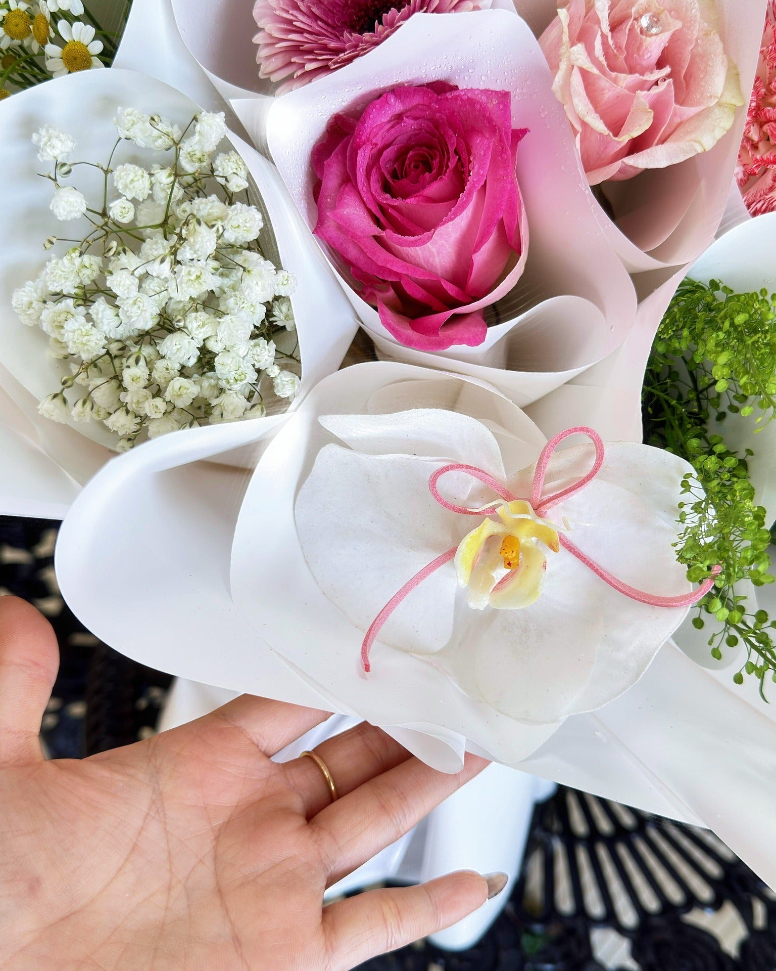 Close-up of a white orchid and pink rose mini bouquet within the Bouquet of Bouquets