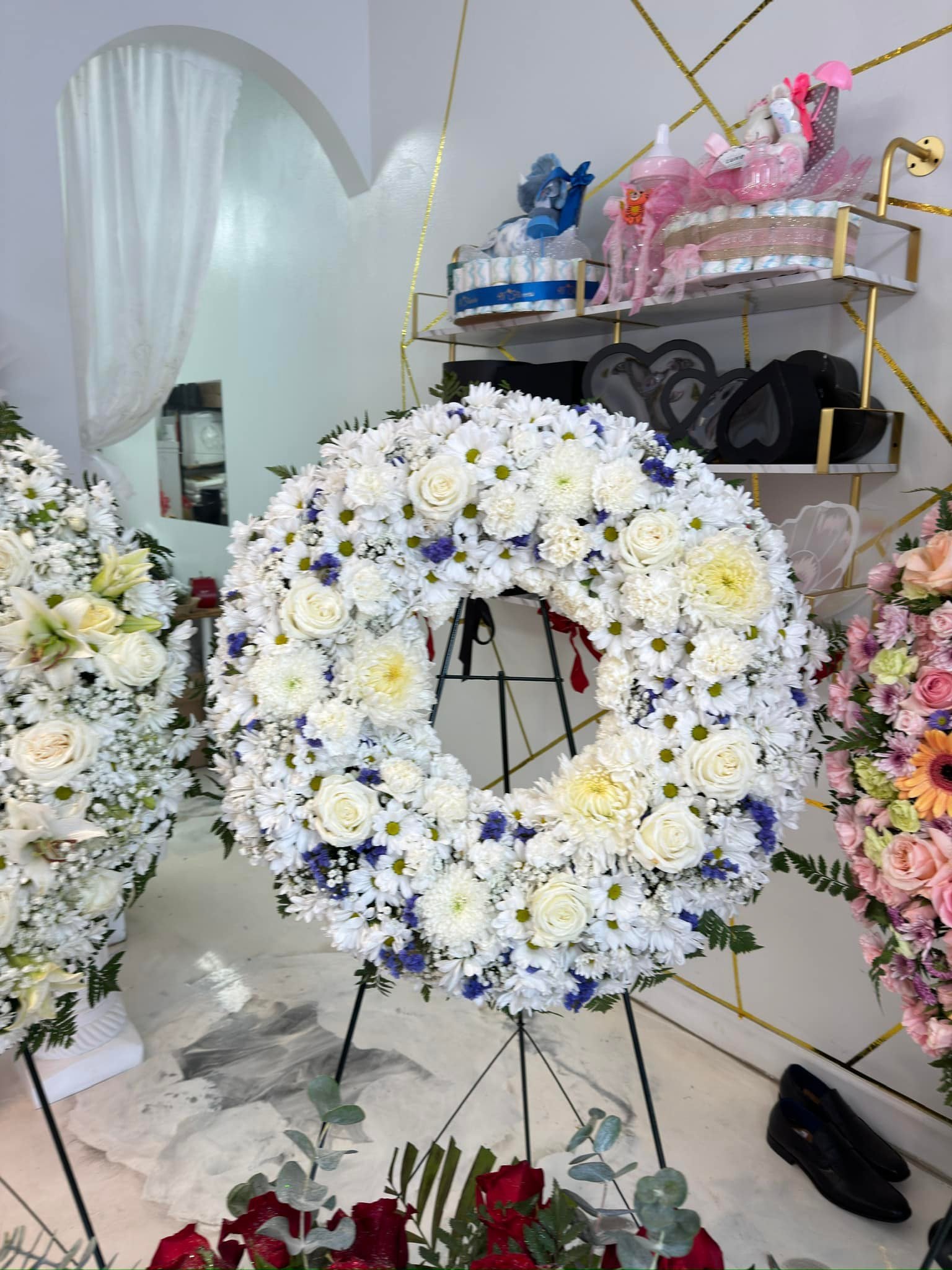 Classic white and blue sympathy standing wreath with roses and chrysanthemums