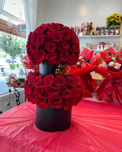 Angled view of The Rose Tower with glittered red roses and black keepsake boxes