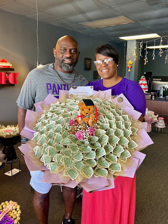 Customers holding a large money bouquet at 98 Flowers