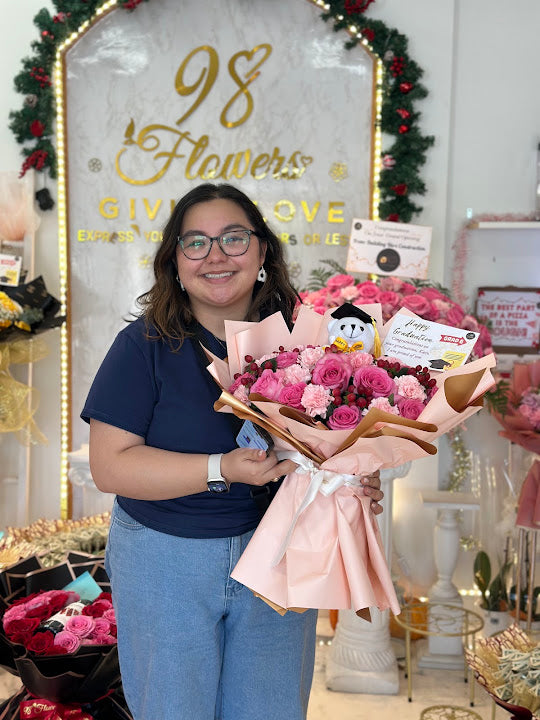 Customer smiling with a pink bouquet at 98 Flowers