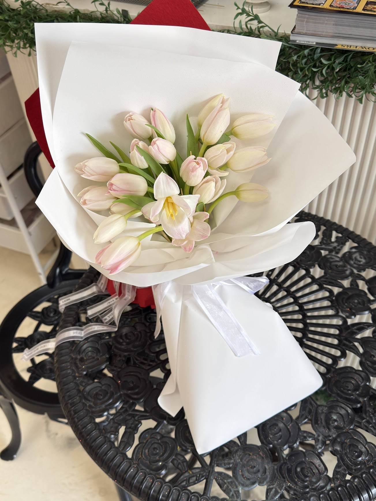 Alternate view of Blush Whisper tulip bouquet with white wrapping and ribbon
