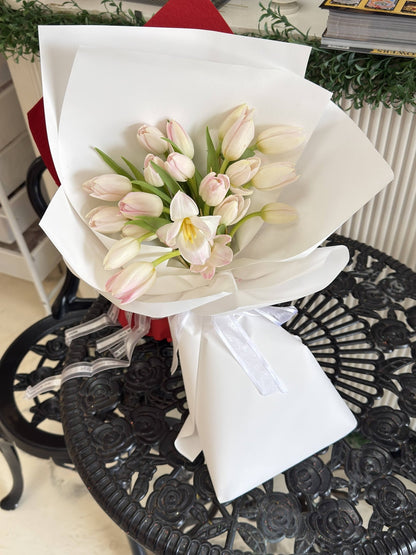 Alternate view of Blush Whisper tulip bouquet with white wrapping and ribbon