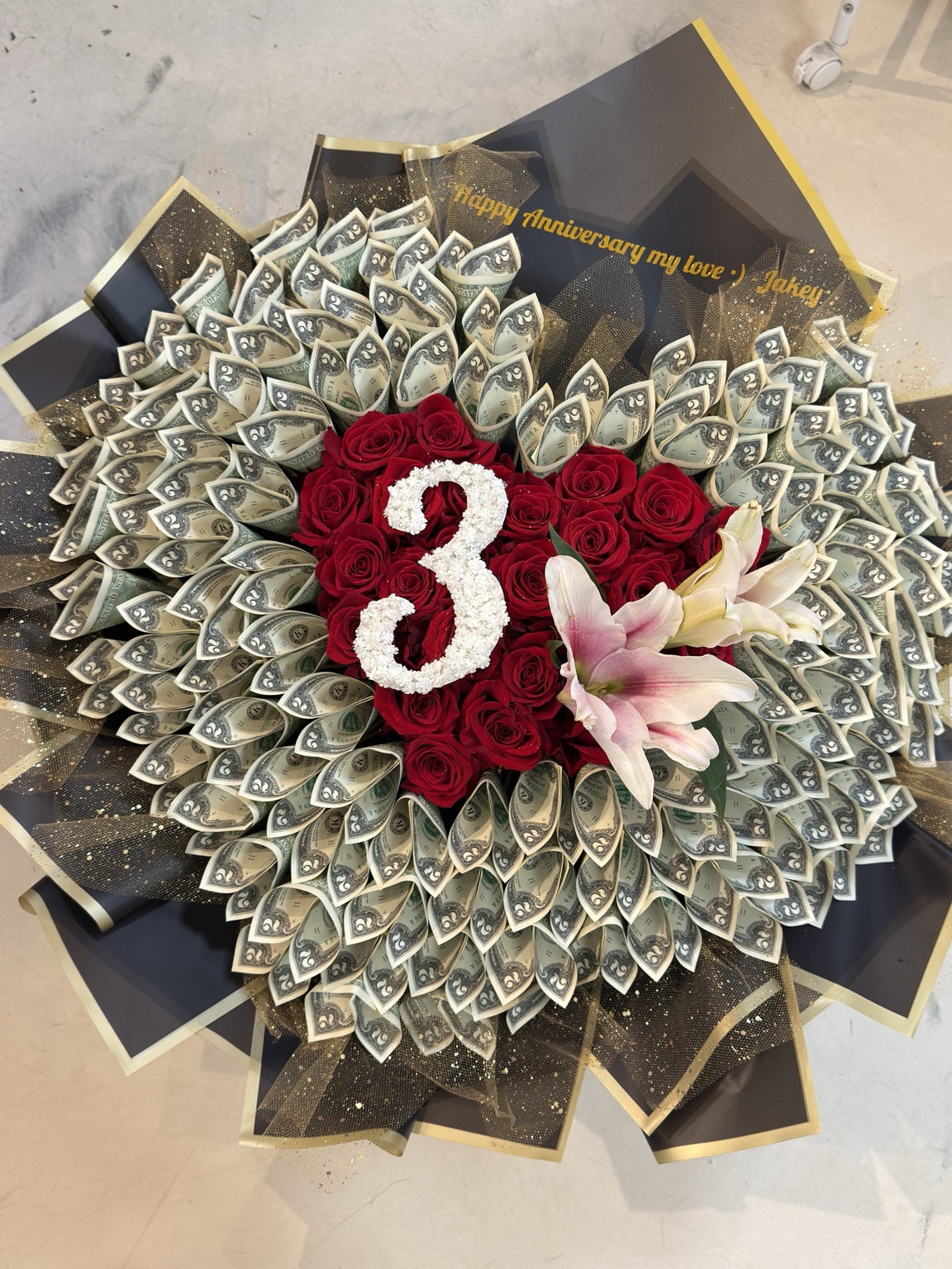 Custom initial heart-shaped money bouquet with $100 cash, red roses and pink lilies