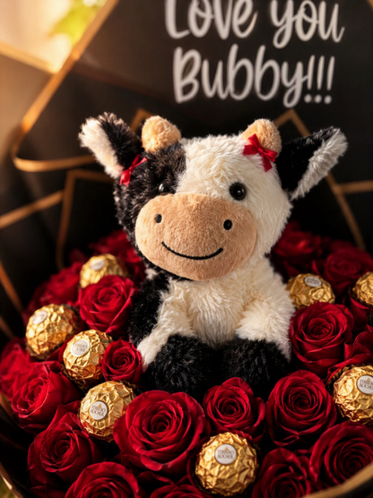 Close-up of Ferrero Rocher chocolates and plush cow arranged among red roses