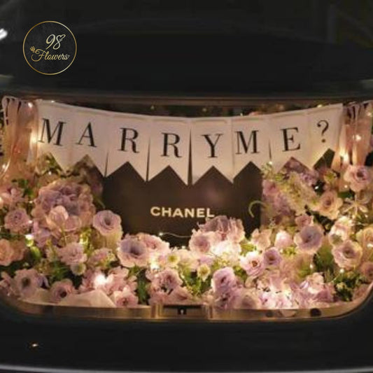 Enchanted Proposal Trunk Arrangement - 98 FLOWERS