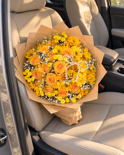 Golden Meadow yellow flower bouquet resting on a car passenger seat for a surprise gift