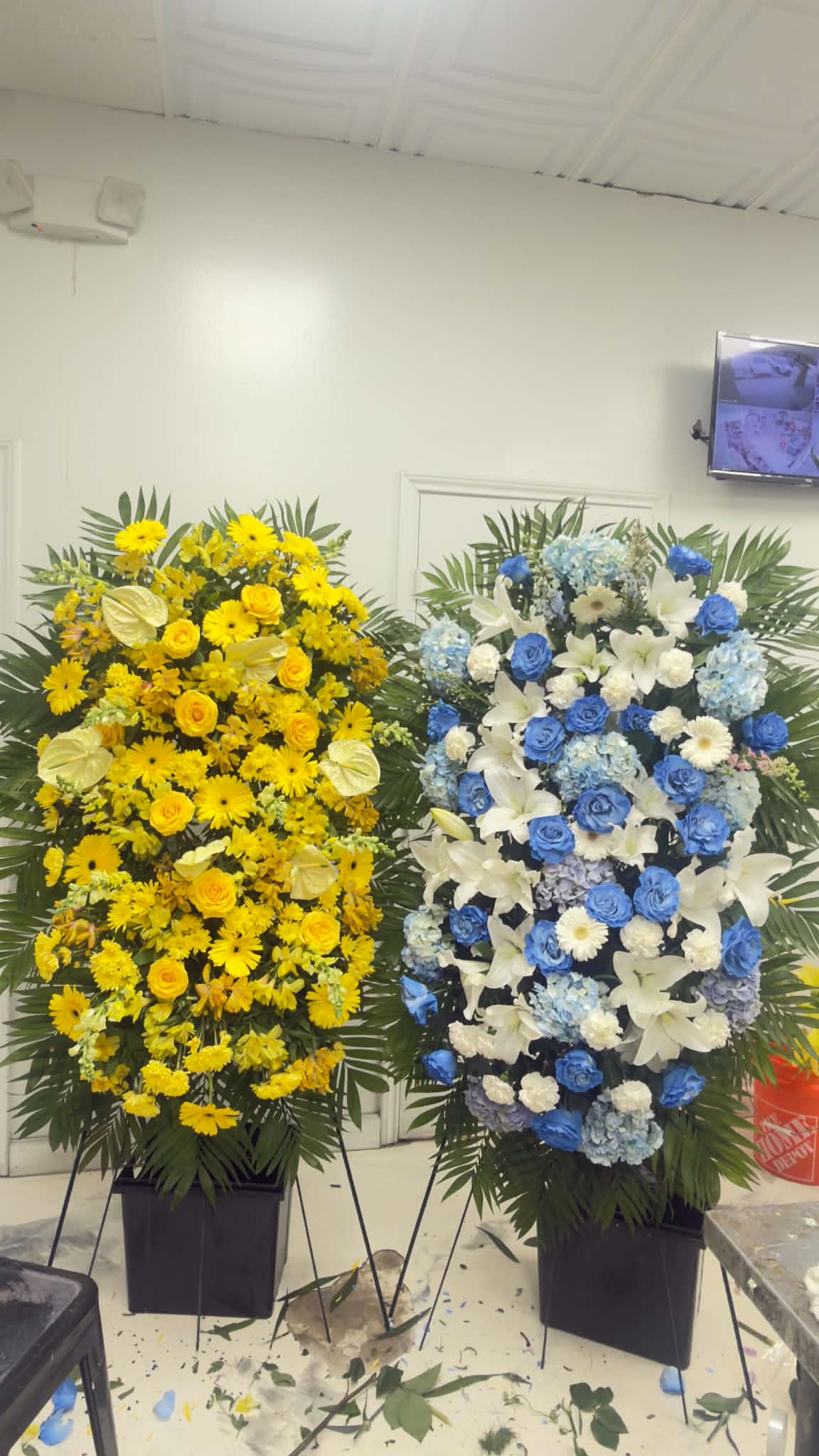 Pair of grand yellow and blue-white sympathy standing sprays