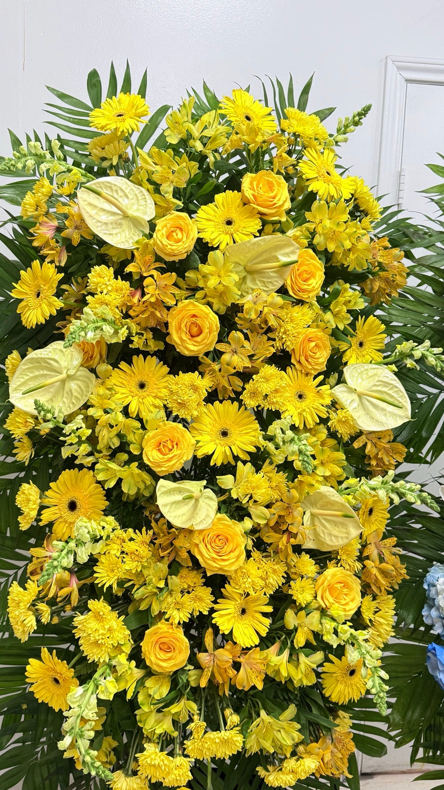 Close view of yellow sympathy flowers with roses, gerberas and anthuriums