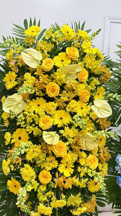 Close view of yellow sympathy flowers with roses, gerberas and anthuriums
