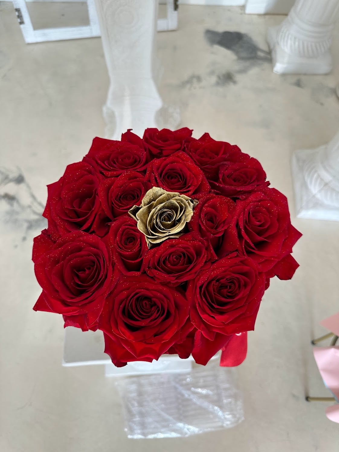 Golden Kiss round red rose box with approximately 15 roses and a gold accent rose
