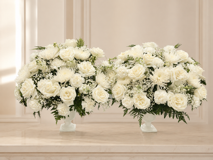 Set of two white funeral flower vases on an elegant ivory memorial background
