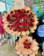 Crimson Celebration Grand Opening Standee mixed flower bouquet, red roses 