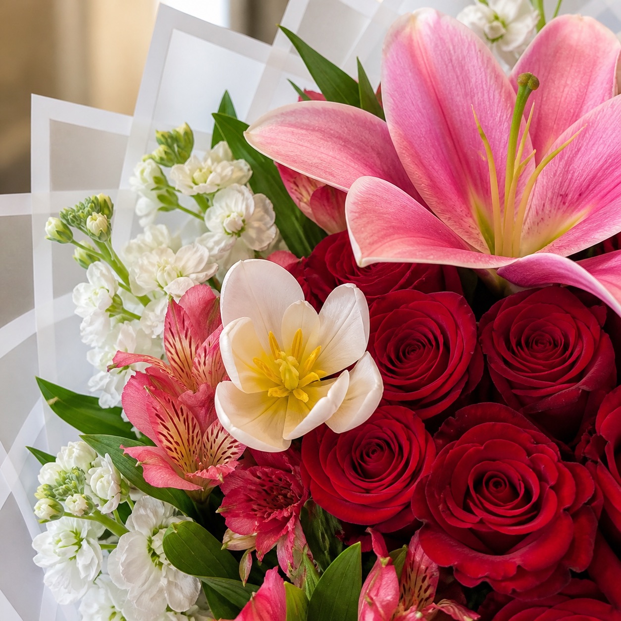 Close-up of red roses, pink lilies, white tulips and garden flowers